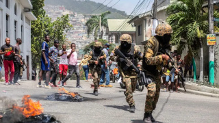 Armed soldiers running away from protestors.